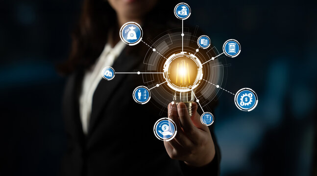 A businesswoman presents a glowing light bulb surrounded by innovation icons, symbolizing ideas and technology in a modern office environment, reflecting growth and vision. Crux