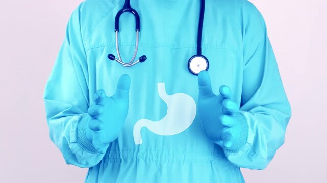 Doctor in light blue surgical scrubs presents a stomach icon, symbol of digestive health, gastric health awareness and early prevention of stomach diseases