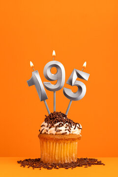 Number 195 candle - Birthday card design in orange background. Cupcake