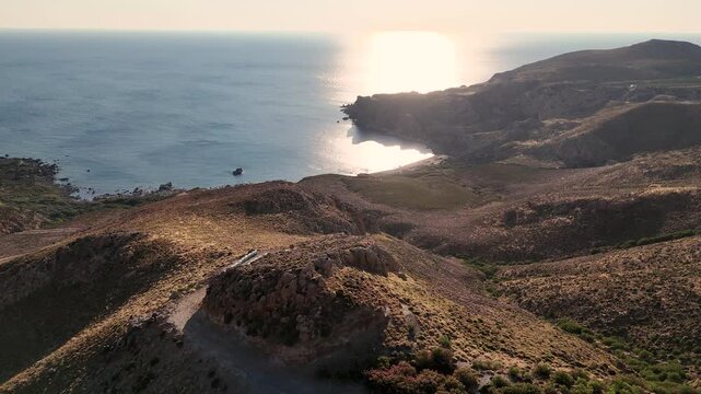 Aerial view of the Aegean sea off the coast of the island Crete in Greece. The vibrant blue ocean water makes a beautiful beach and dramatic coastline. 