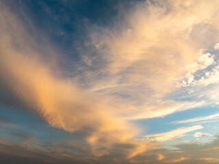 Fototapeta premium Golden clouds in a blue sky with beautiful sunset colors