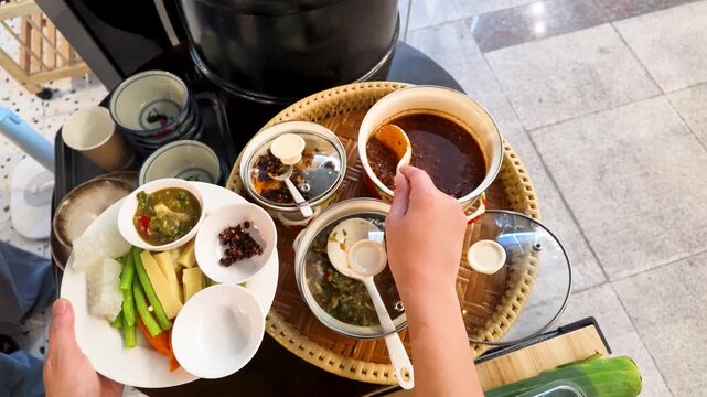 Serving Traditional Burmese Spicy Dip with Vegetable Platter