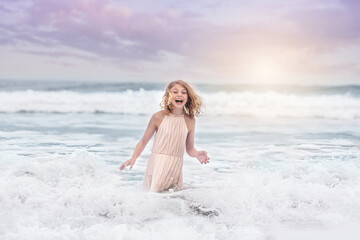 Happy Young Girl Playing in Ocean Waves at the Beach © Emily