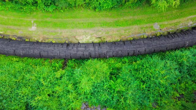 Summer aerial view featuring the 3.4 mile long wooden penstock in Vermont known as The Snake that runs from the Searsburg Dam to a generating station along the Deerfield River with an 8 foot diameter