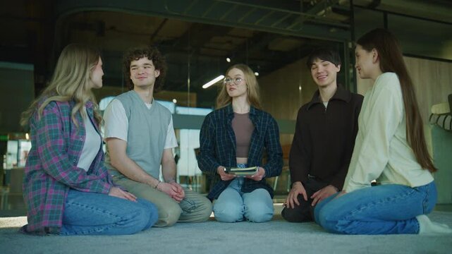 In a modern therapy session, the psychologist joins the circle, exchanging high-fives and hugs with the group to celebrate unity and support.