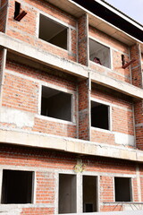 Obraz premium exterior view of brick house under construction with concrete structure
