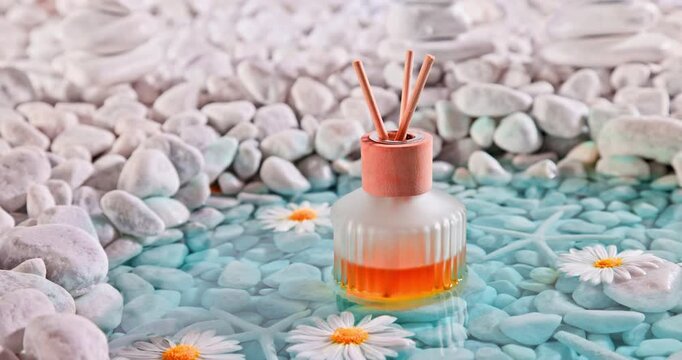 Sophisticated diffuser fragrance on the shore of sea ??white stones.