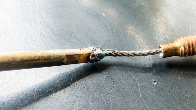 The soldered brake cable is positioned, connected, or joined using solder.