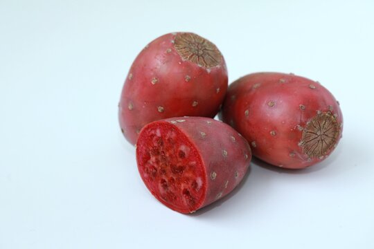 Prickly pear cactus fruits, whole and half sliced opuntia isolated on white background.