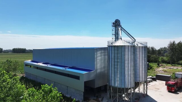 modern grain storage center with silos and warehouse building