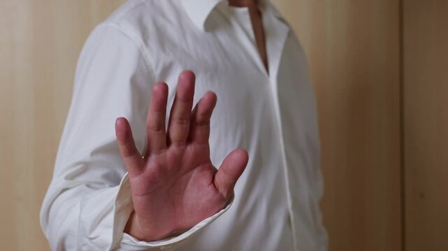Hand gesture meaning rejection. Waving hand towards camera. Human hand gesture, common hand movement.