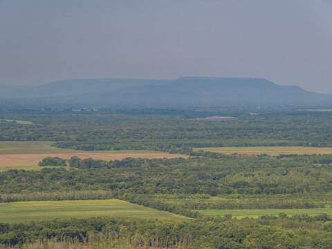 Aerial view of rolling green hills and forested valleys in Arkansas