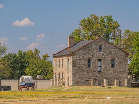 Historic stone building and covered wagon at Fort Smith National Historic Site