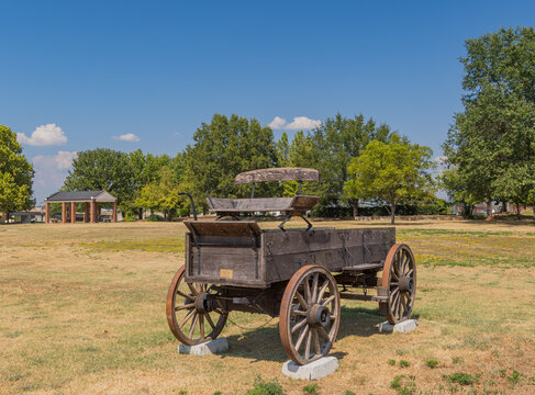 Vintage wooden wagon on display in a grassy field
