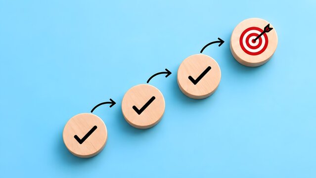 Upward business progress strategy wooden blocks with checkmarks and arrows leading to red dartboard target