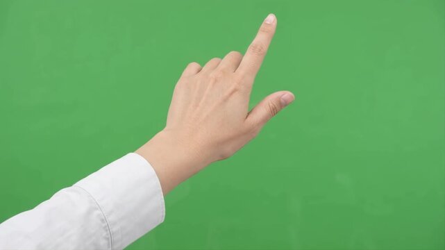 Human hand performing smooth swipe gestures in multiple directions against a clean green screen background for touchscreen and virtual interface concepts.