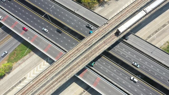 Aerial top View of busy freeway, rush hour heavy traffic jam highway. Aerial view of multiple roads, electrical train in city, vehicular intersection, expressway with important
