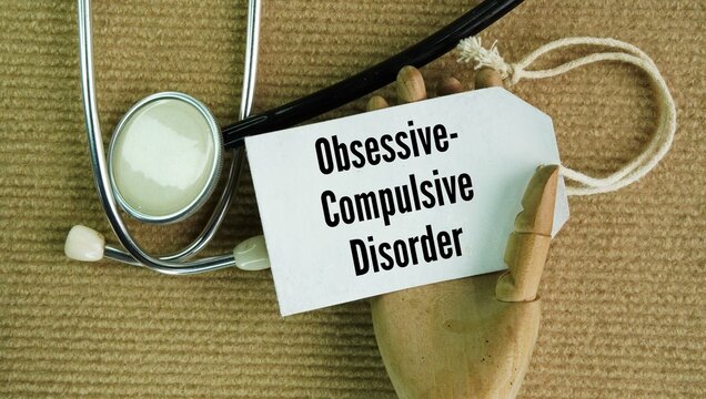 Stethoscope and paper tag with the word Obsessive-compulsive disorder OCD. chronic mental health condition involving a cycle of unwanted, distressing thoughts, obsessions