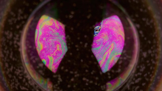 Fluorescent circle. Neon fluid flow. Round colorful lens light flare. Soap bubble paint liquid mix swirl purple glow defocused background.