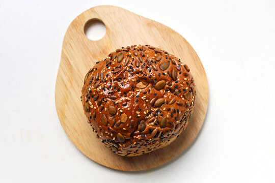 Healthy multigrain bread bun topped with mixed seeds and grains