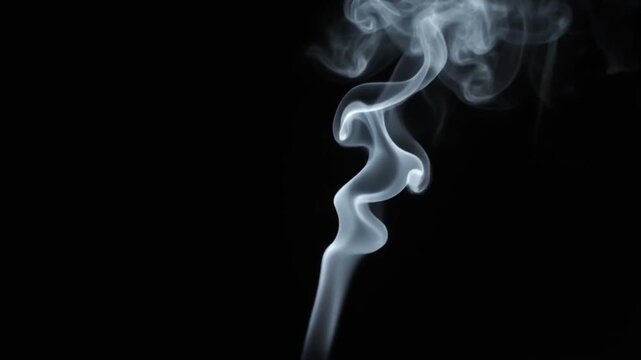 White smoke rising slowly on black background video. Wispy vapor trails swirling and dissolving in dark studio lighting. Cinematic movement for overlay, transition, or atmospheric background.