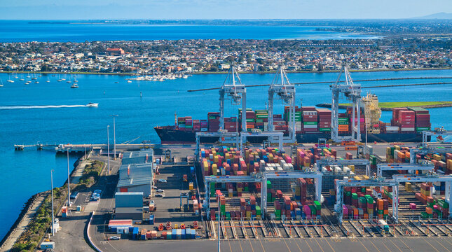Overhead view of cranes loading container ships at port