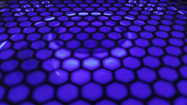 Abstract colorful hexagon mesh background with glowing neon rainbow lights. Futuristic digital honeycomb pattern loop for motion graphics tech stage design and EDM club backdrop.