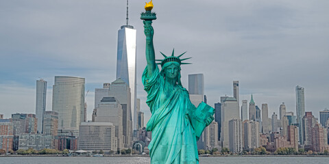 Statue of Liberty in NYC, USA. Liberty statue above NYC. NYC panorama with iconic America statue Liberty. New York City skyline with Liberty statue. © Volodymyr