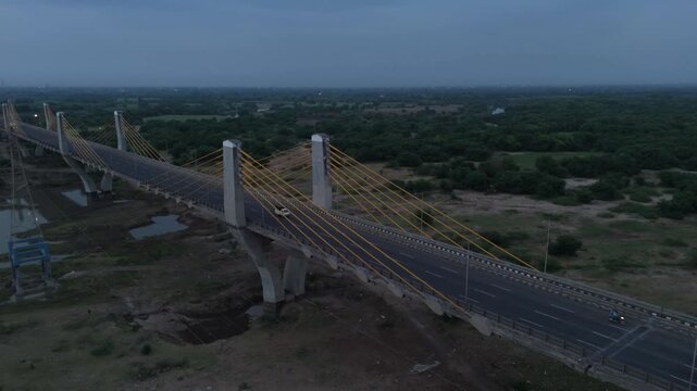 Aerial drone view of cable stayed bridge crossing a highway with surrounding landscape in Bharuch Gujarat India