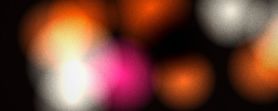 Abstract bokeh background with warm orange and pink light circles. Soft out of focus glowing orbs on black. Festive blurry light spots for holiday celebration and night party.