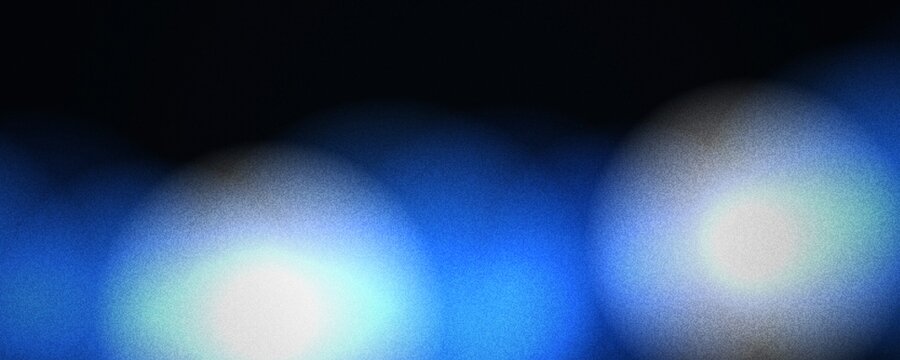 Abstract blue bokeh background with soft glowing light spheres. Cinematic dark blue blur texture for digital wallpaper. Ethereal out of focus light orbs on black backdrop.