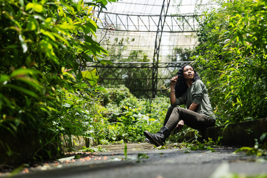 Woman Taking a Peaceful Break During Nature Exploration in a Botanical Dome