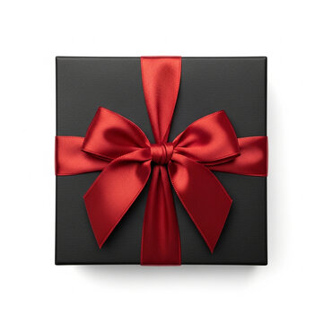 Top view of a square black gift box wrapped with a vibrant red satin ribbon and bow, isolated on white background