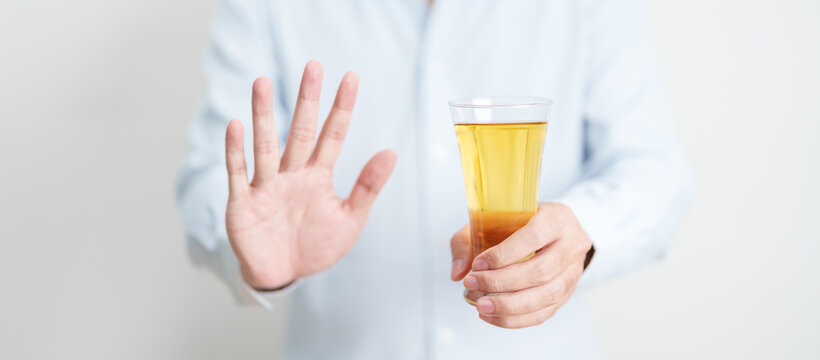 man making stop hand gesture to refuse a glass of Beer, Healthy man say no to alcohol drink, stop alcoholism and addiction concept. Responsible man reject a drink before driving and quit booze