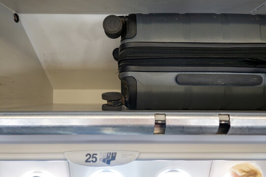 Frankfurt, Germany A suitcase in an overhead bin in a commercial plane.