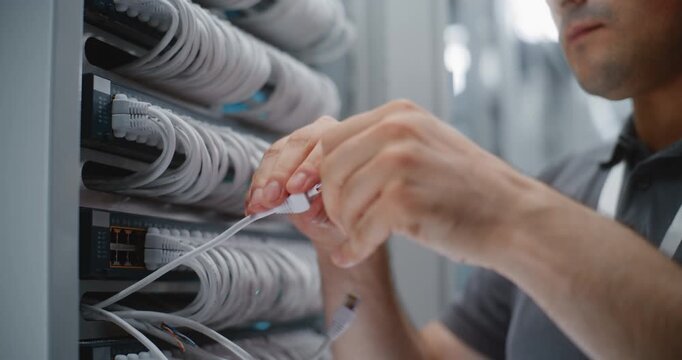 Network Technician Strips Outer Jacket From Cat6 Ethernet Cable With Multifunction Crimper, Exposing Twisted Pair Conductors for Pinout Preparation and Custom Patch Cord Assembly in Server Room.