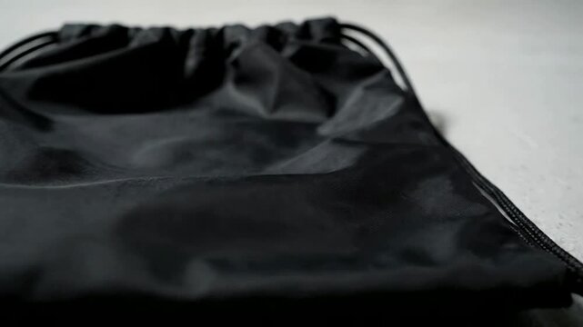 High-resolution mockup of a neutral-toned nylon drawstring bag displayed on a flat lay setup with ample white copy space for branding text