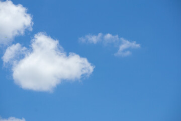 Fototapeta premium Beautiful blue sky with white clouds on a sunny day background