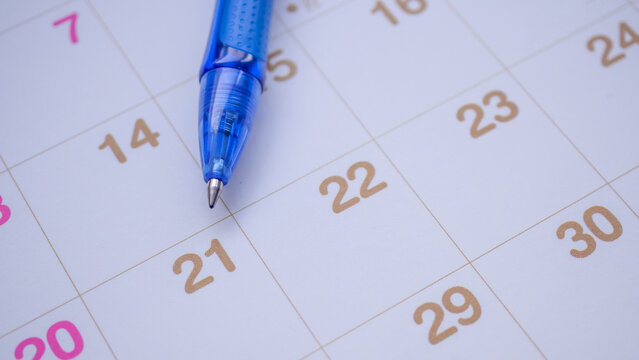 Blue pen on calendar page background business planning appointment meeting concept