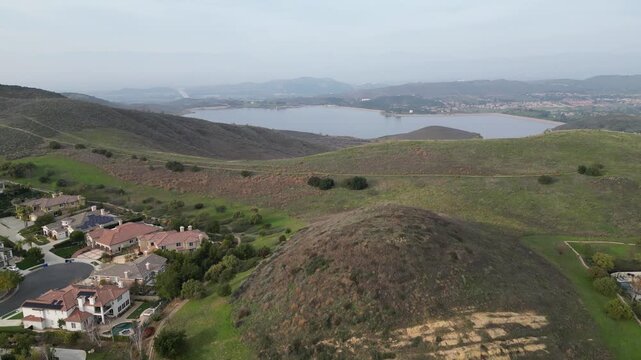 Bard Lake, or Wood Ranch Reservoir, a large reservoir on the border of Thousand Oaks and Simi Valley, California. Lifting up, shot on an overcast afternoon in January 2024.