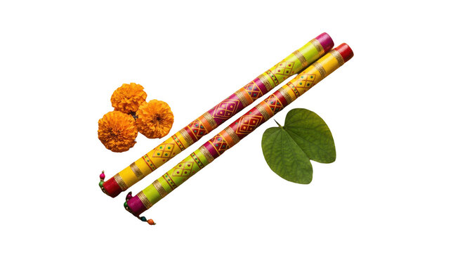 Colorful decorated dandiya sticks with marigold flowers and green leaves for dussehra and navratri festival celebration