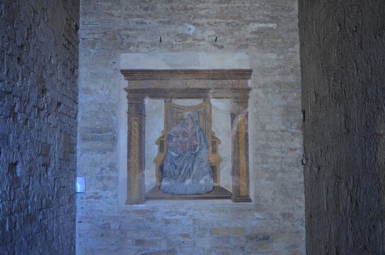 San Gimignano, Italy 03.04.2020: Madonna and Child Enthroned, a 15th-century work located under the Loggia of the Palazzo del Popolo