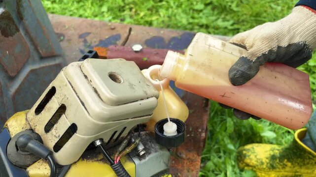 Hands Filling the Fuel Tank of Outdoor Power Equipment