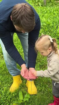 Adult Helping a Young Child Explore Garden Berries