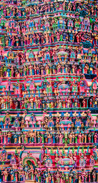 Close-up view of intricate and brightly painted religious sculptures adorning the gopuram of Madurai Meenakshi Amman Temple, photographed ahead of Thirukkudamuzuku Kumbabhishekam consecration ceremony