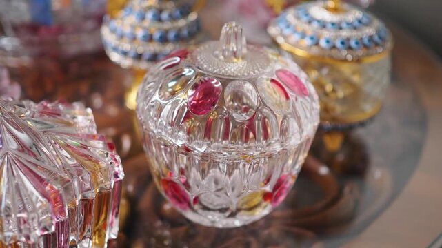 Clear crystal containers with colorful designs on a table