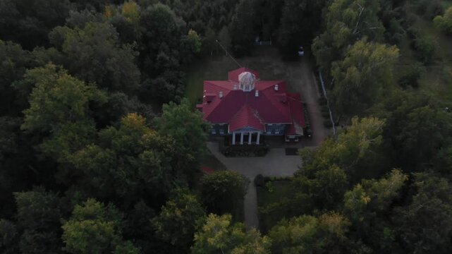 Drone pulls back and tilts up from the manor in Zvenigorod
