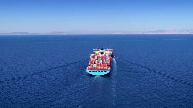 Aerial rear view of a industrial container cargo ship traveling over the ocean as a concept for transport and shipping