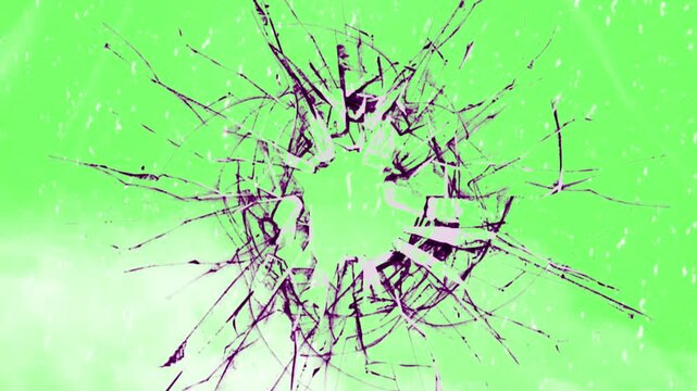 Glass shattering into sharp pieces with a central impact hole radiating cracks across a bright green screen backdrop for digital editing and compositing.