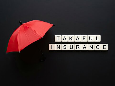 Red miniature umbrella with Takaful Insurance text tiles on black backdrop suitable for Islamic finance promos symbolizing sharia protection